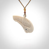Hand carved huia bird made from cow bone pendant. Carved for NZ Pacific by Fumio Noguchi. This is a contemporary piece of jewellery that is carved with intricate detail and clearly shows a beautiful bird. We ship this free worldwide.